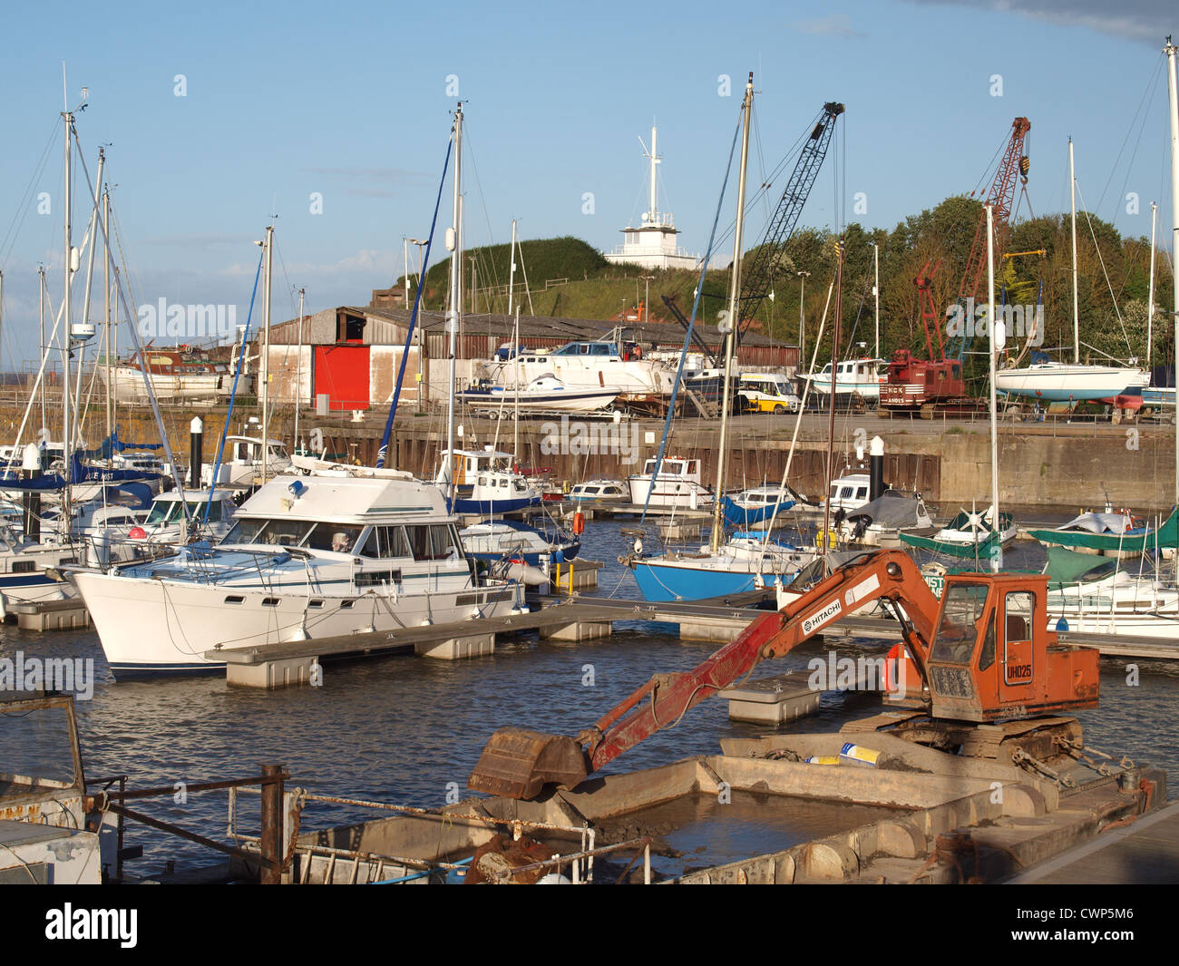 Watchet harbour and boat yard with dredger in foreground Somerset. UK Stock Photo