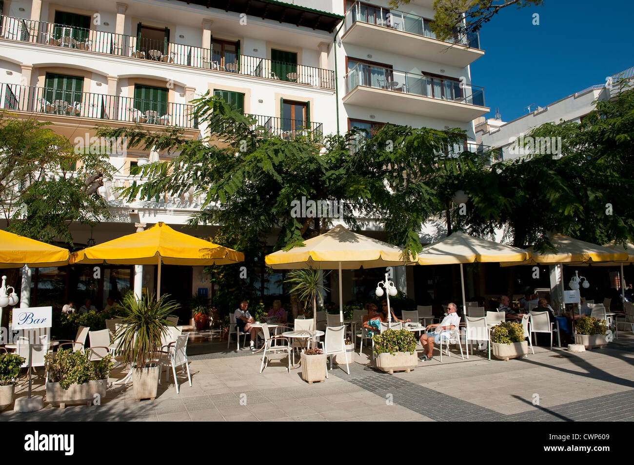 People sitting and eating al fresco outside a restaurant in Puerto Pollensa, Mallorca, Spain. Stock Photo