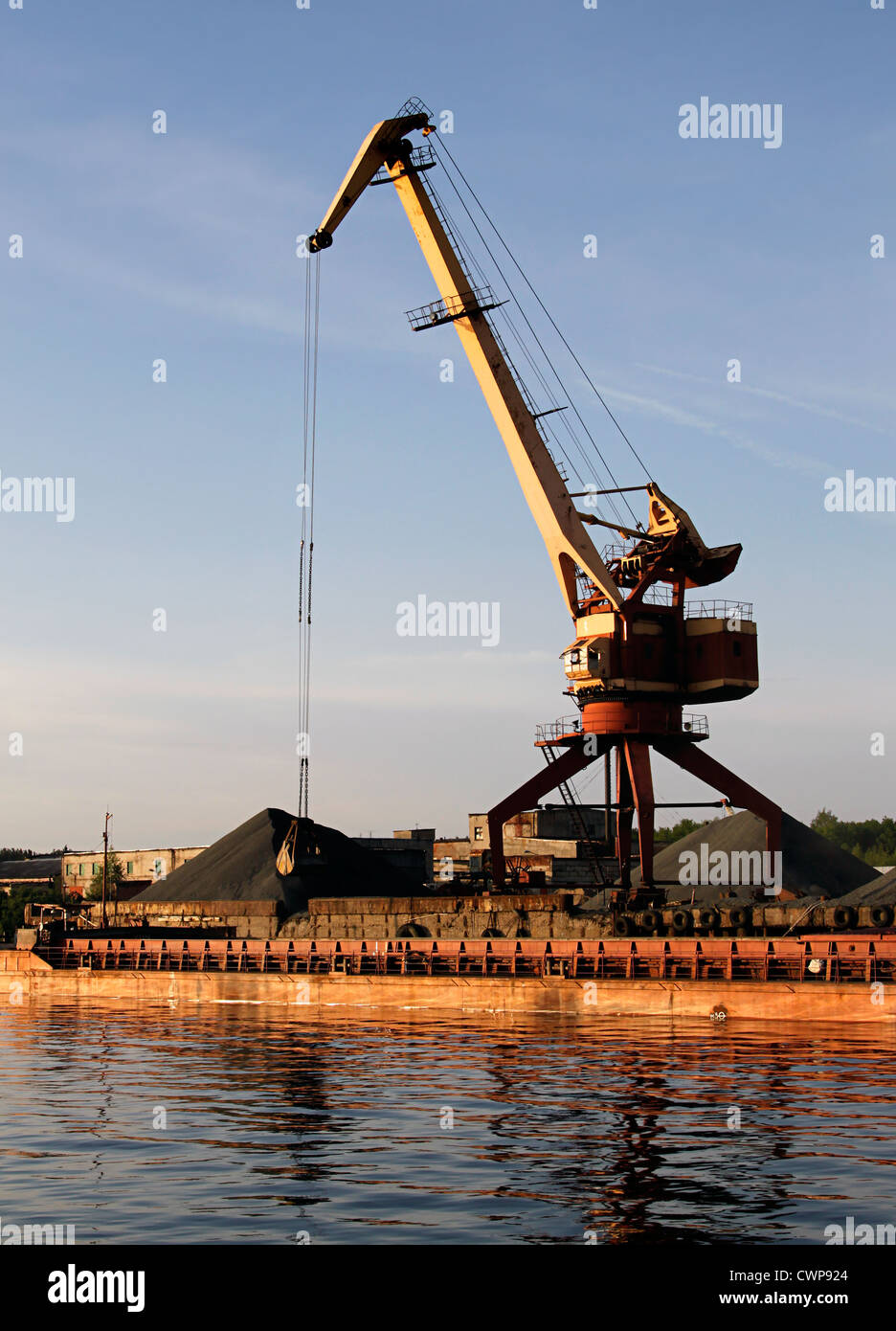 Port bulk crane and barge Stock Photo