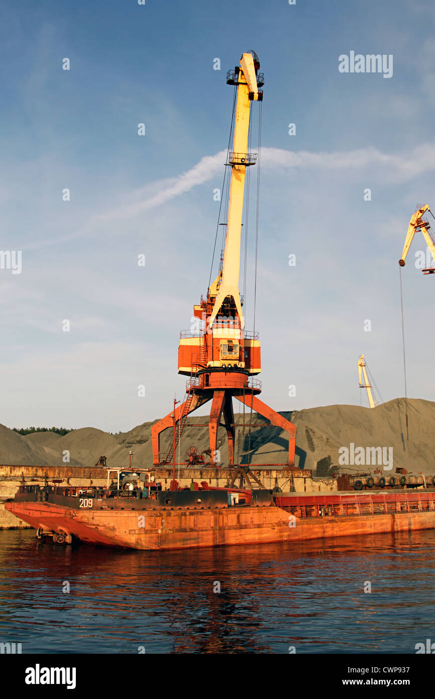 Port bulk crane and barge Stock Photo