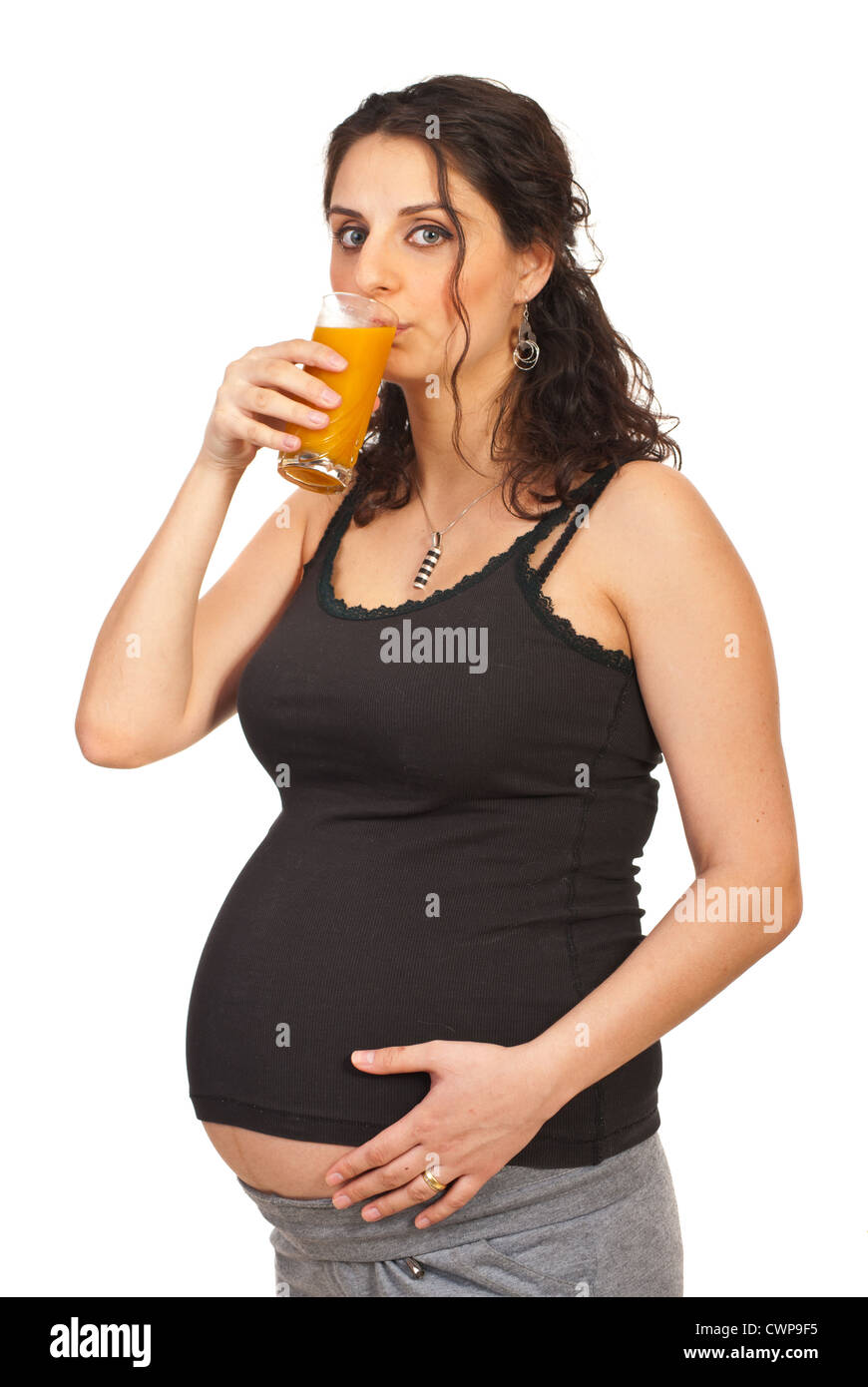 Pregnant woman drinking orange juice isolated on white background Stock ...