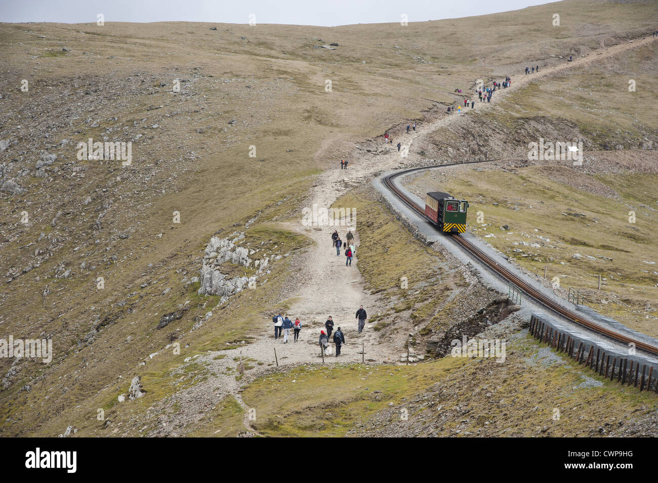 Walkers and train on mountain, Snowdon Mountain Railway, Snowdon, Snowdonia N.P., Gwynedd, North Wales, may Stock Photo