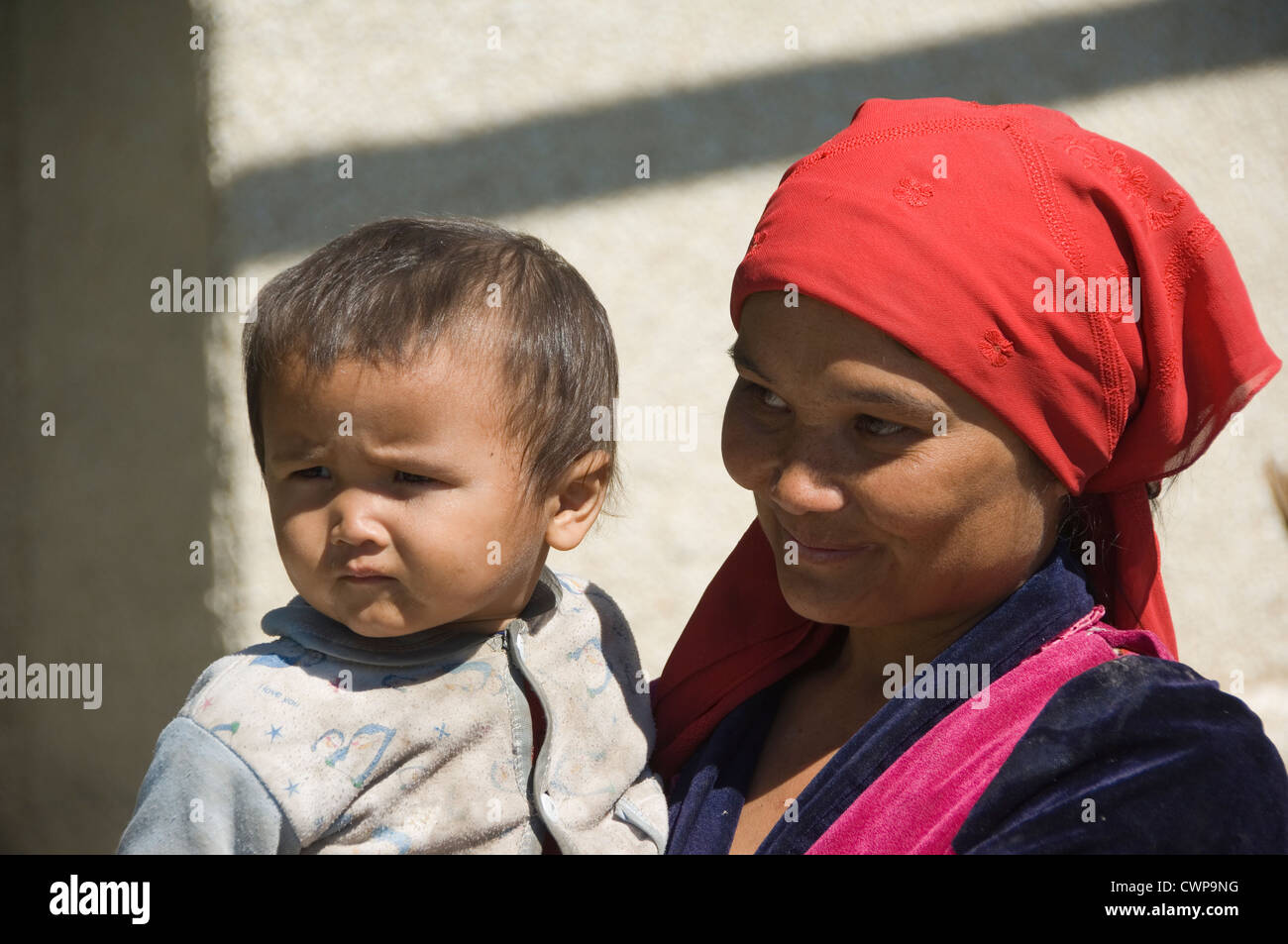 Young Uzbek woman with her child, Uzbekistan Stock Photo