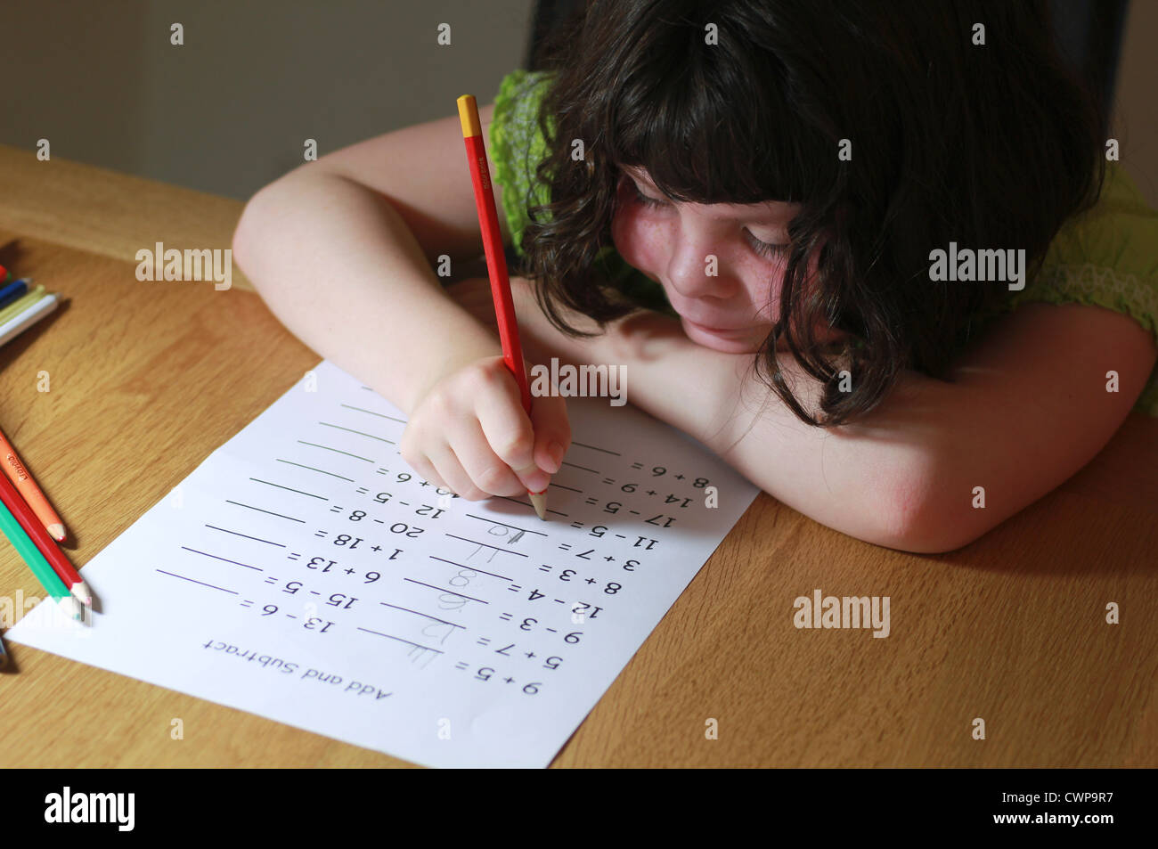 Little girl doing maths homework Stock Photo