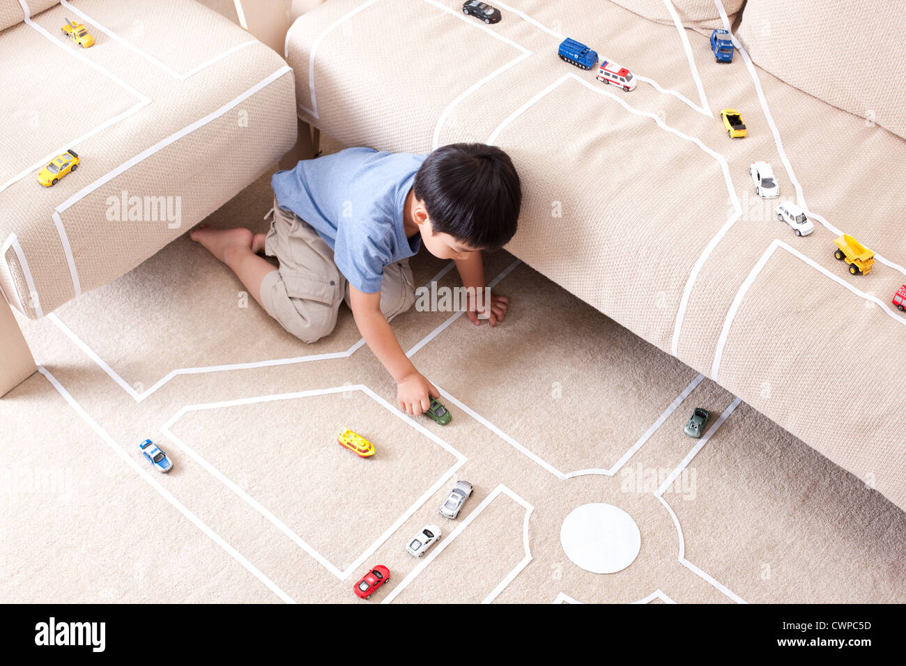 Boy playing toy car at home Stock Photo - Alamy