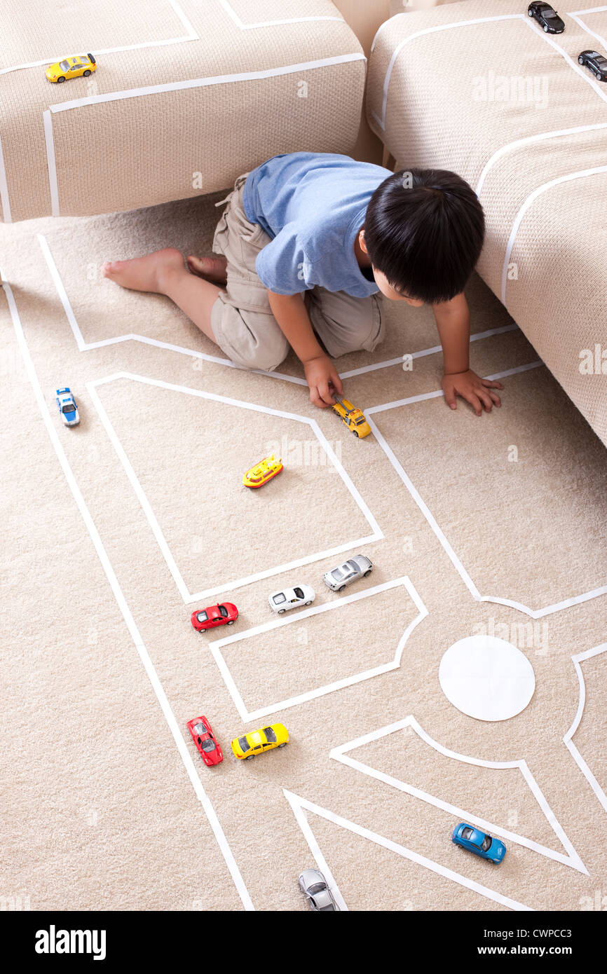 Boy playing toy car at home Stock Photo - Alamy