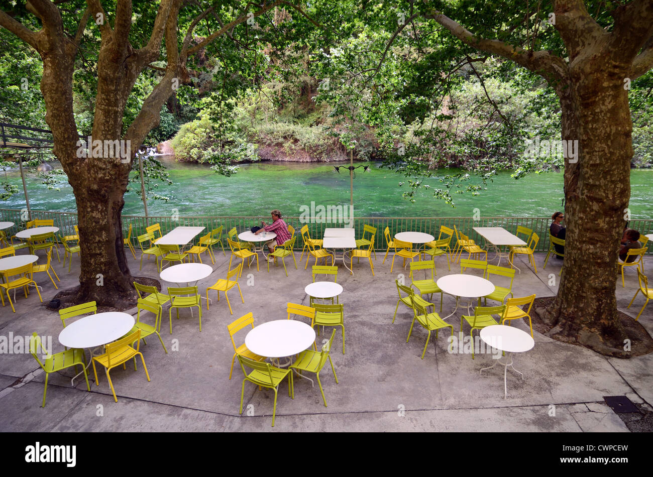 Single Client in an Otherwise Deserted Pavement Cafe, Sidewalk Cafeor Riverside Restaurant along River Sorgue at Fontaine-de-Vaucluse Provence France Stock Photo