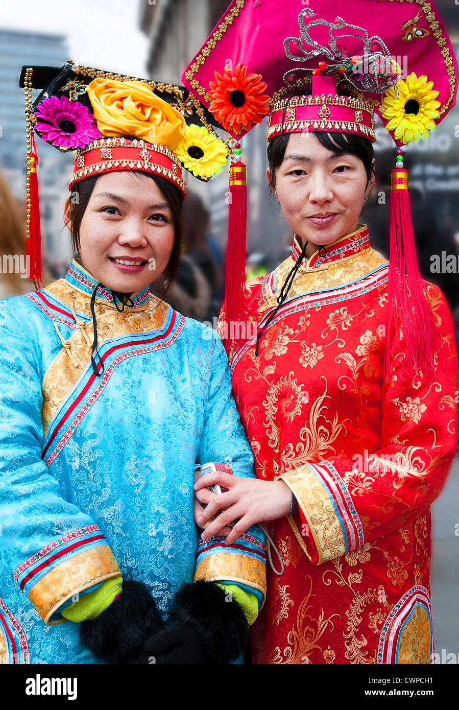 UK. England. London. Two Chinese women in traditional costume during Chinese New Year celebrations. Stock Photo