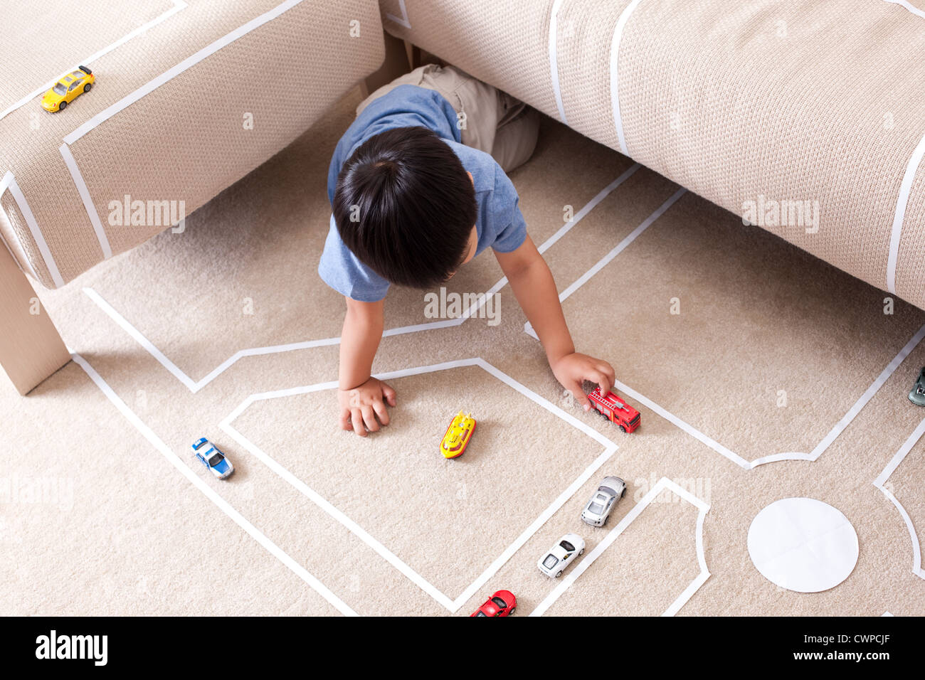 Boy playing toy car at home Stock Photo - Alamy