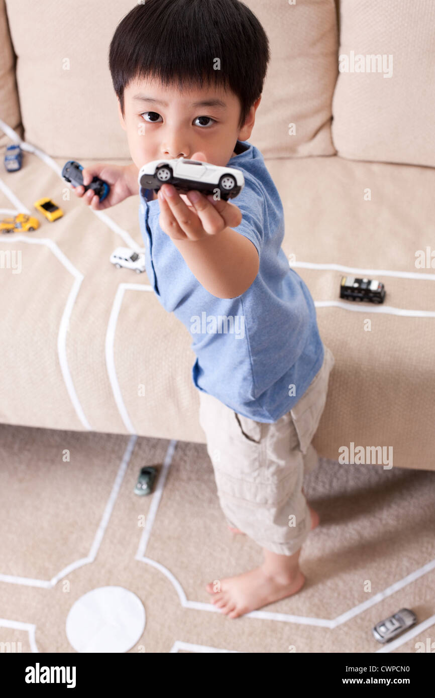 Boy playing toy car at home Stock Photo - Alamy