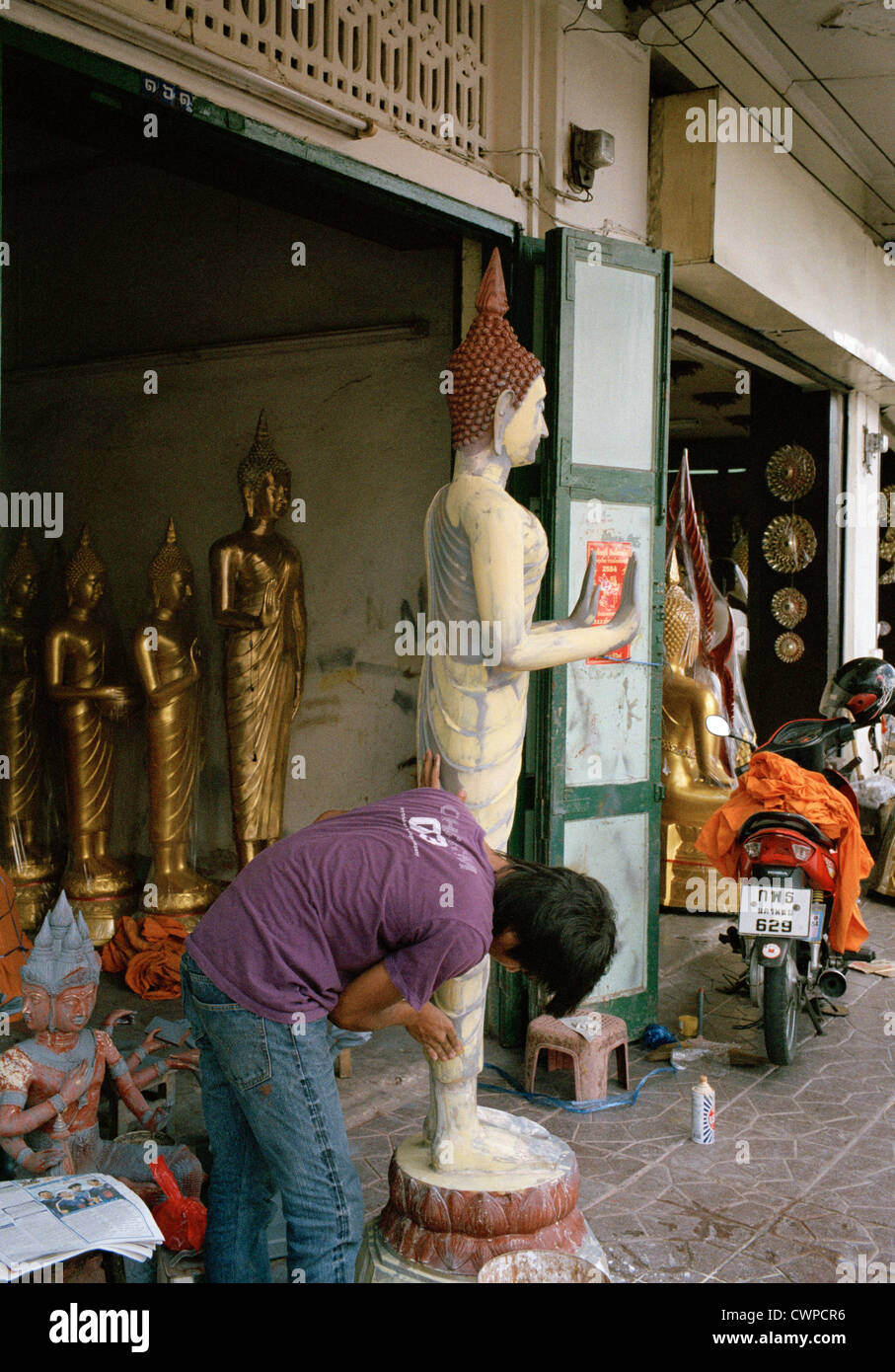 Buddhist sculpture in Bangkok in Thailand in Far East Southeast Asia. People Shop Work Occupation Worker Art Working Business Reportage Travel Stock Photo