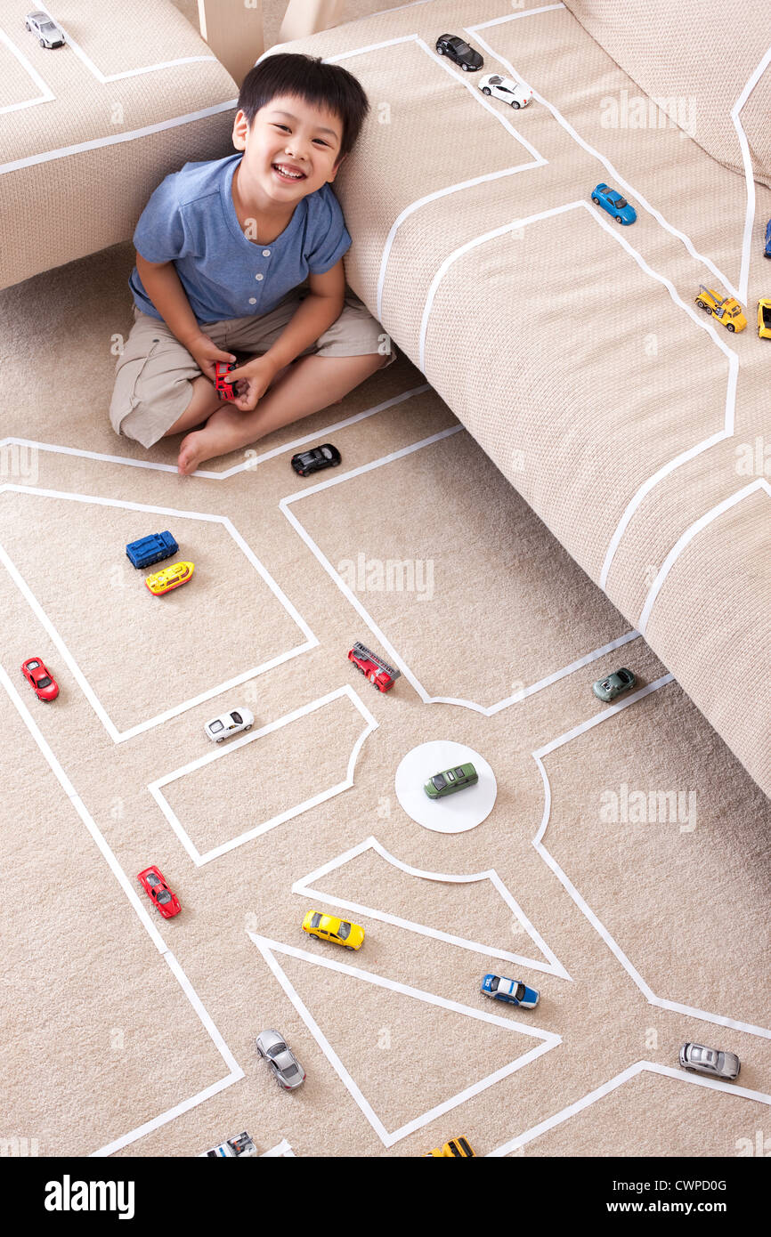 Boy playing toy car at home Stock Photo - Alamy