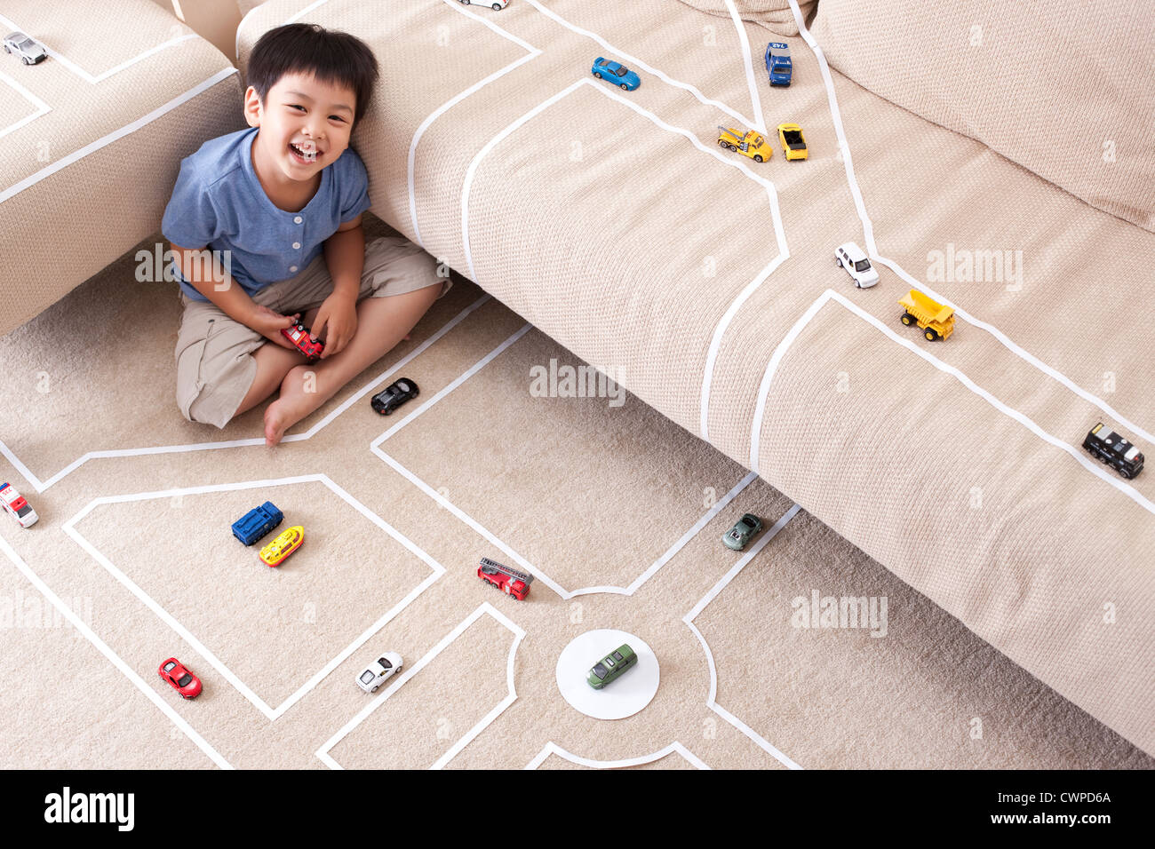 Boy playing toy car at home Stock Photo - Alamy