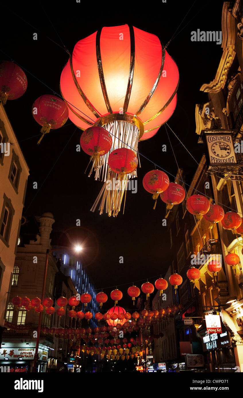 UK. England. London. Hanging lanterns in night street scene. Chinatown during Chinese New Year celebrations. Stock Photo