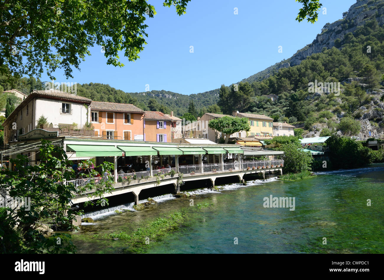 Riverside Restaurants along River Sorgue at Fontaine-de-Vaucluse Vaucluse Provence France Stock Photo