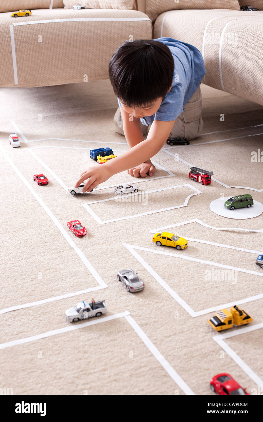 Boy playing toy car at home Stock Photo - Alamy