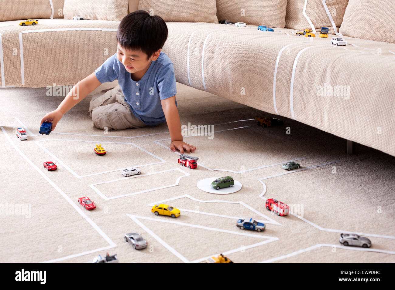 Boy playing toy car at home Stock Photo - Alamy