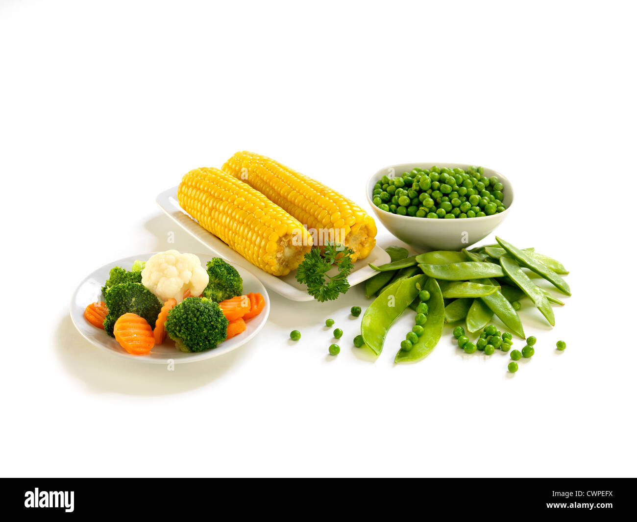 corn, carrot, broccoli, peas on isolated white background Stock Photo