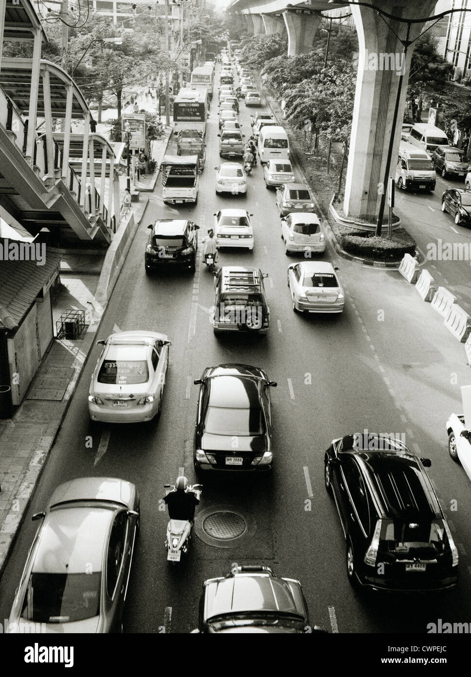 Traffic in Sukhumvit in Bangkok in Thailand in Far East Southeast Asia. Modern City Cities Urban Car Cars b&w Travel Stock Photo