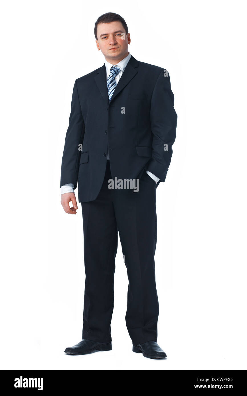 Full length of a confident young business man standing against white ...