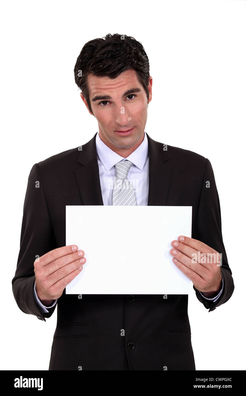 Man in suit showing blank sheet of paper Stock Photo Alamy