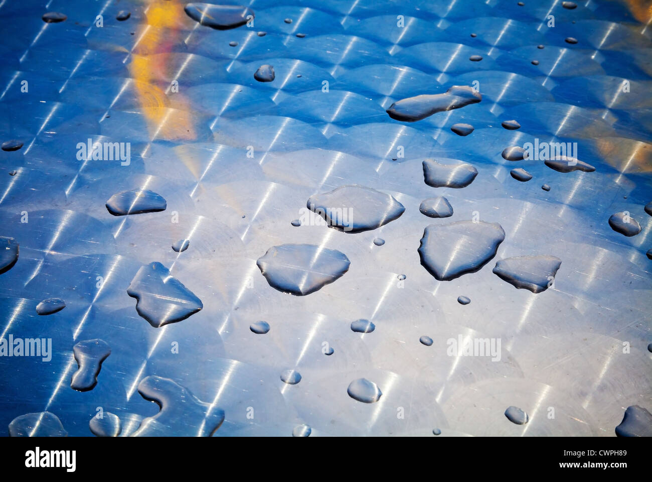 Texture of water drops on shining metal table surface with scratches and circular milling Stock Photo