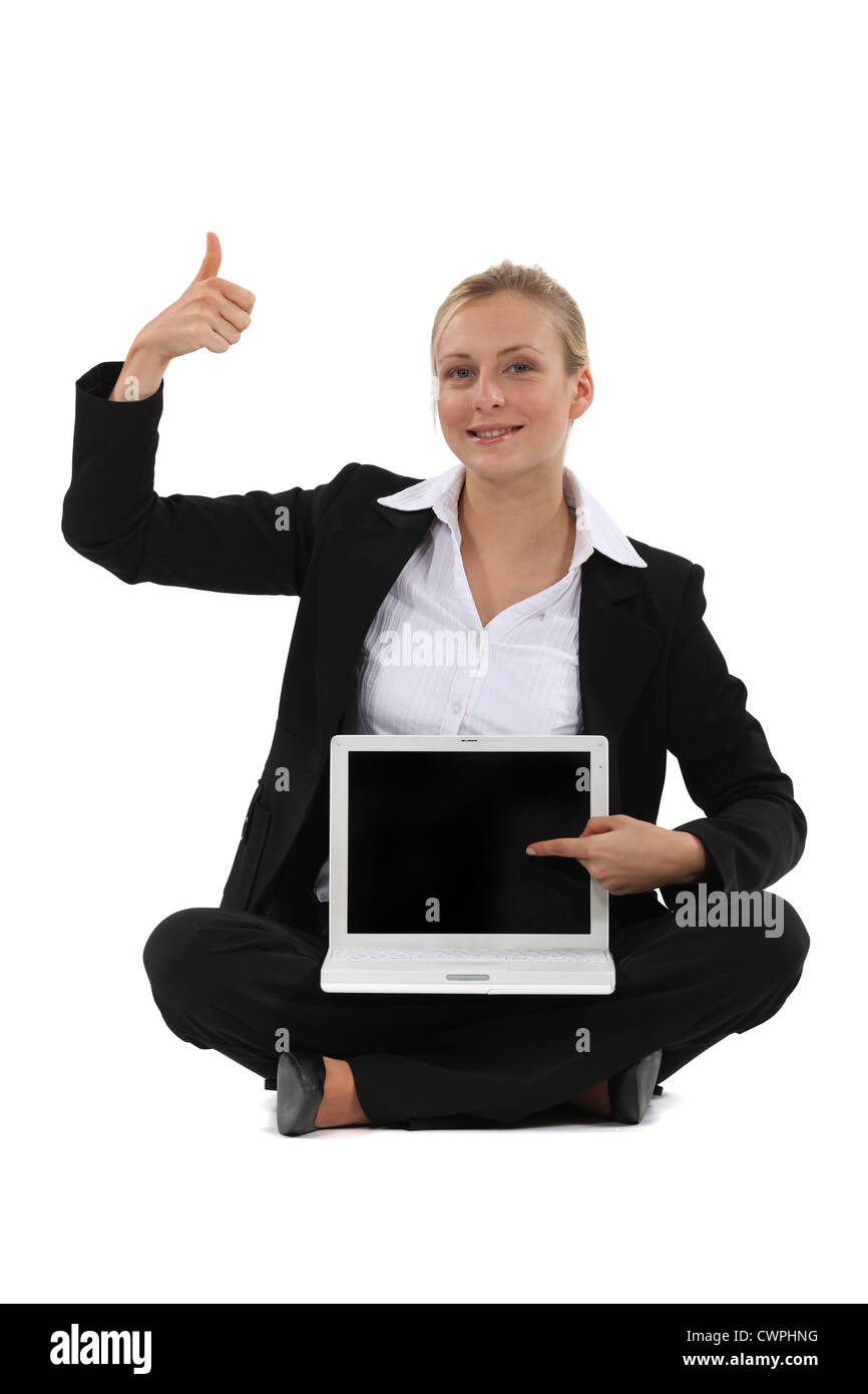 woman holding a laptop and making a thumbs up sign Stock Photo - Alamy