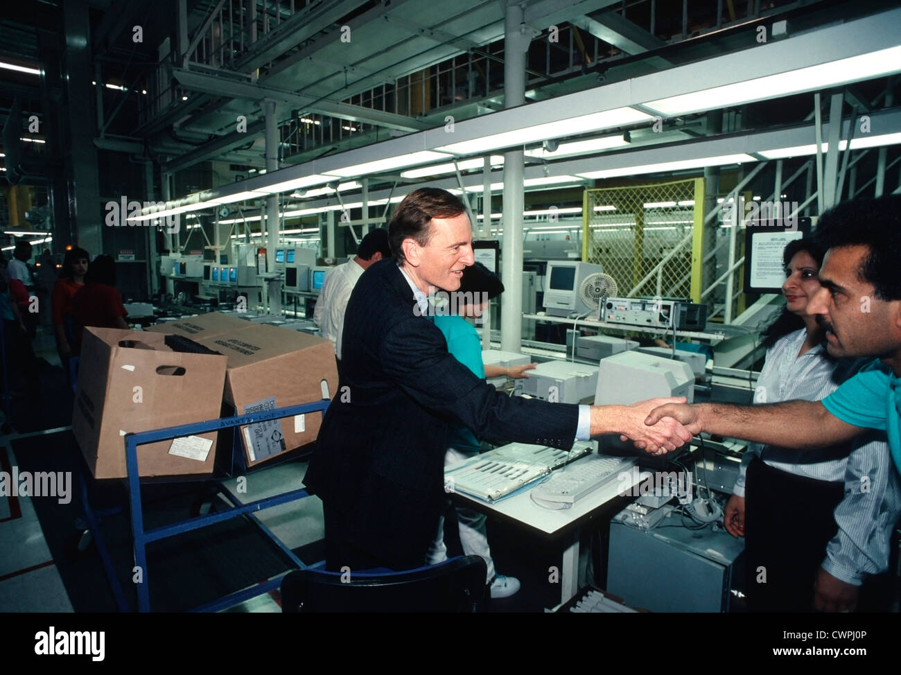 John Sculley, Apple CEO from 1983 until 1993, Shakes hands with Apple  employees at the Apple assembly Plant in Freemont, CA Stock Photo
