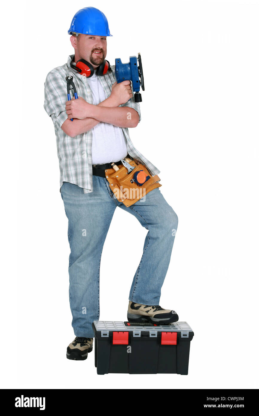 Handyman holding power sander Stock Photo