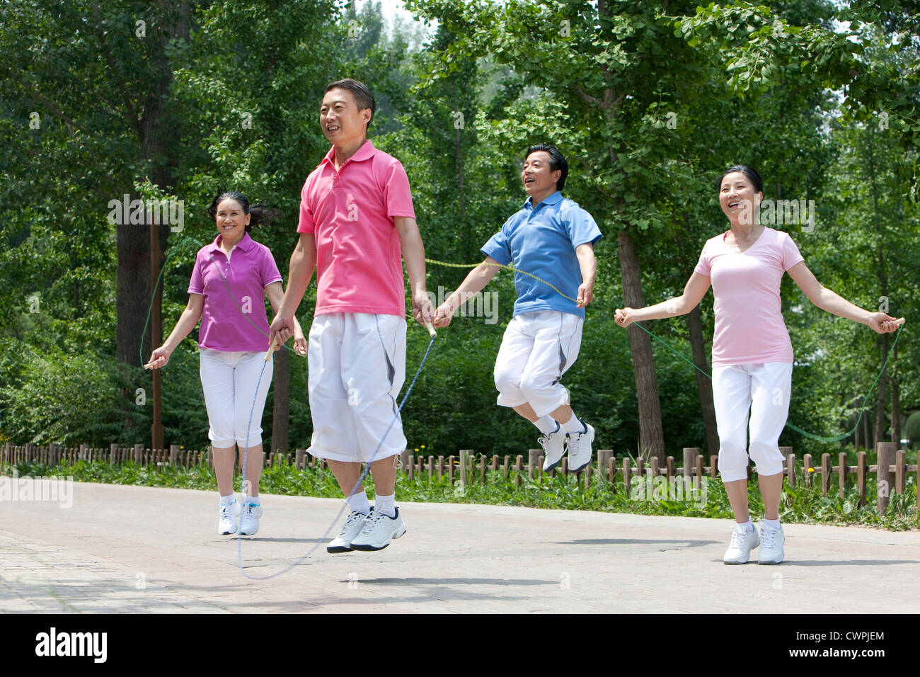 Seniors playing jumping rope in park Stock Photo - Alamy
