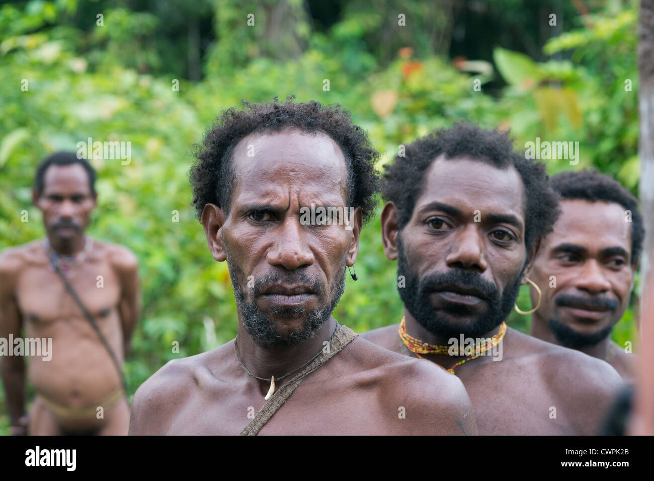 Group of Korowai people on the natural green forest background Stock Photo