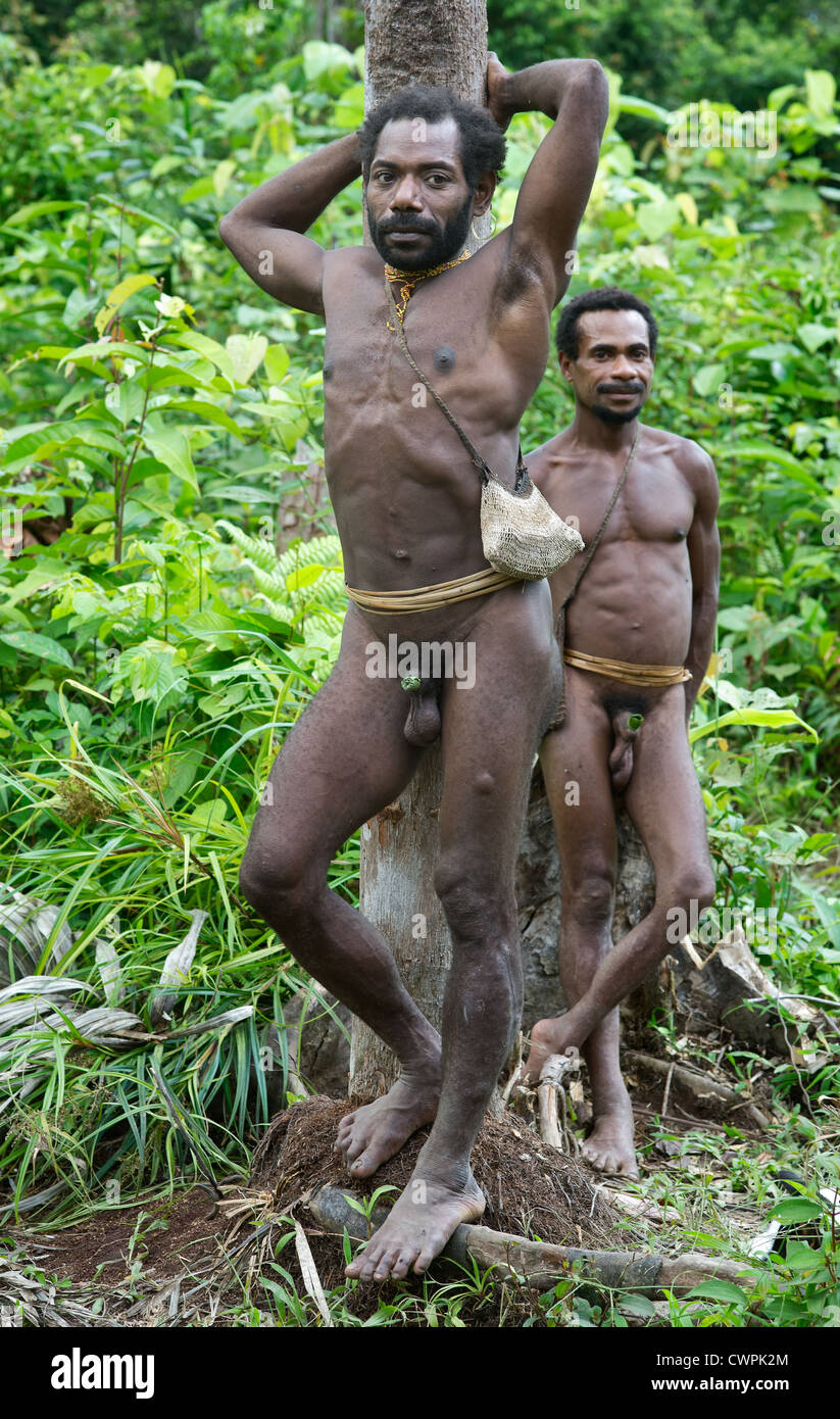 Portrait of two Korowai man on the green forest background Stock Photo