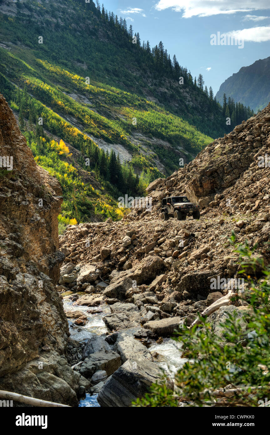 A Jeep® ascends the Shofield Pass road just below Devil's Punchbowl near Crystal, Colorado Stock Photo