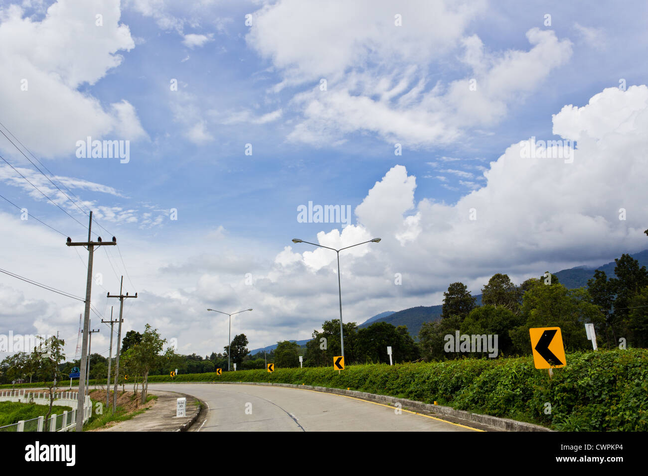 Road Signs warn Drivers for Ahead Dangerous Curve. Stock Photo