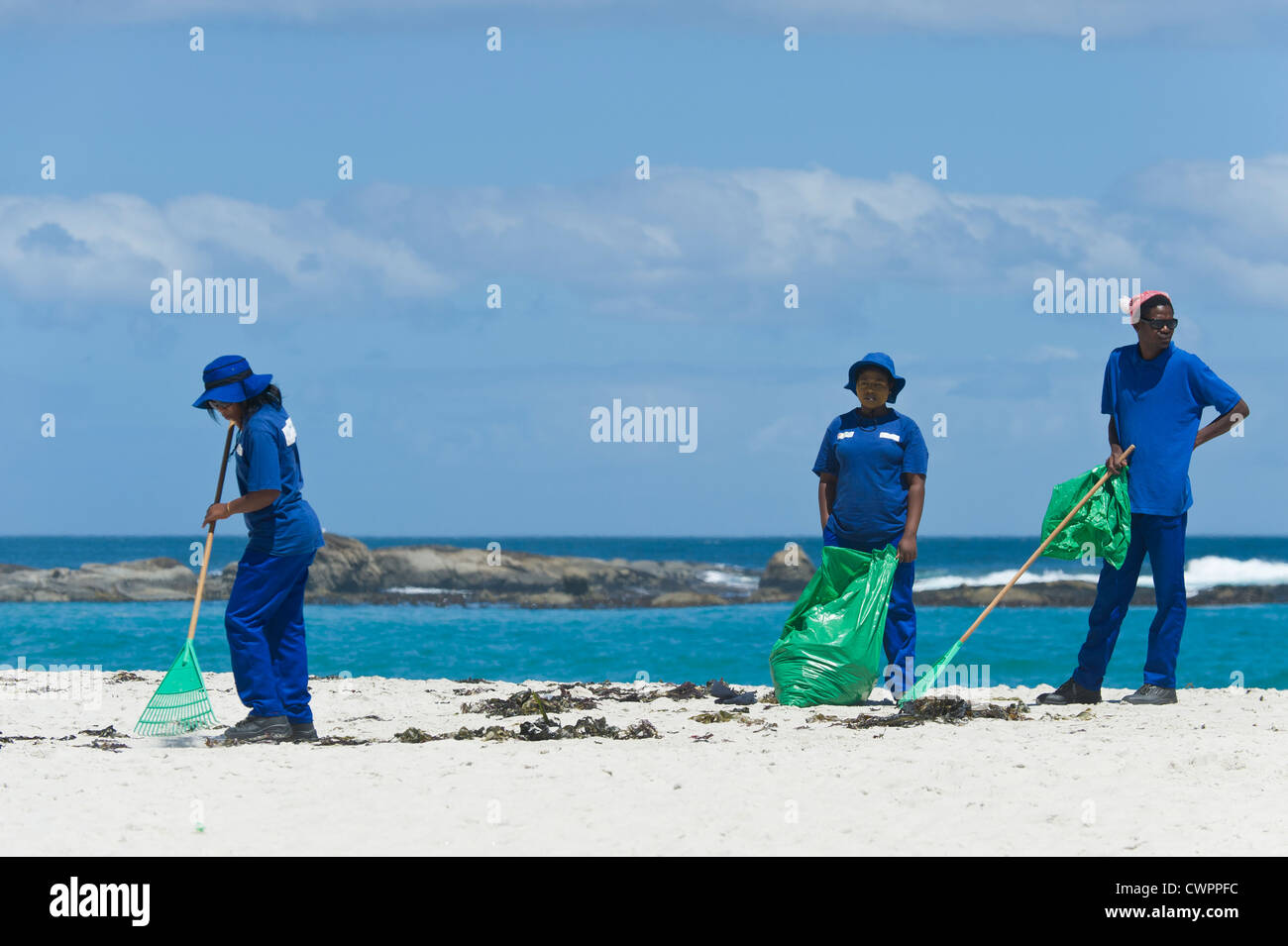 Workers cleaning the beach of Camps Bay, Cape Town, South Africa Stock