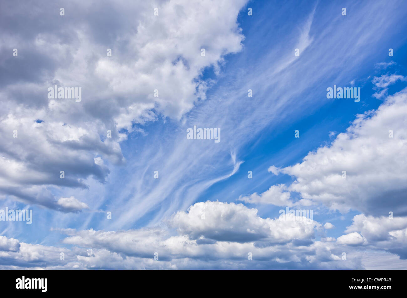 Formation of big clouds on a blue summer sky. Stock Photo