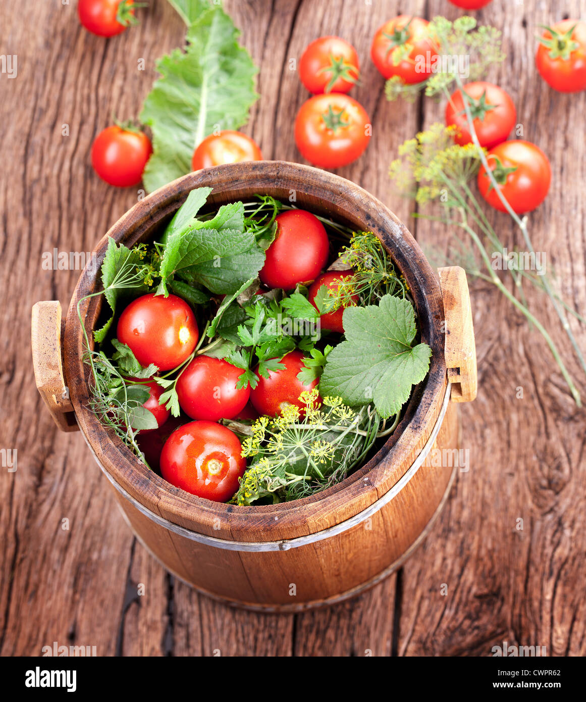 Barrel of pickled tomatoes on an old wooden table Stock Photo - Alamy