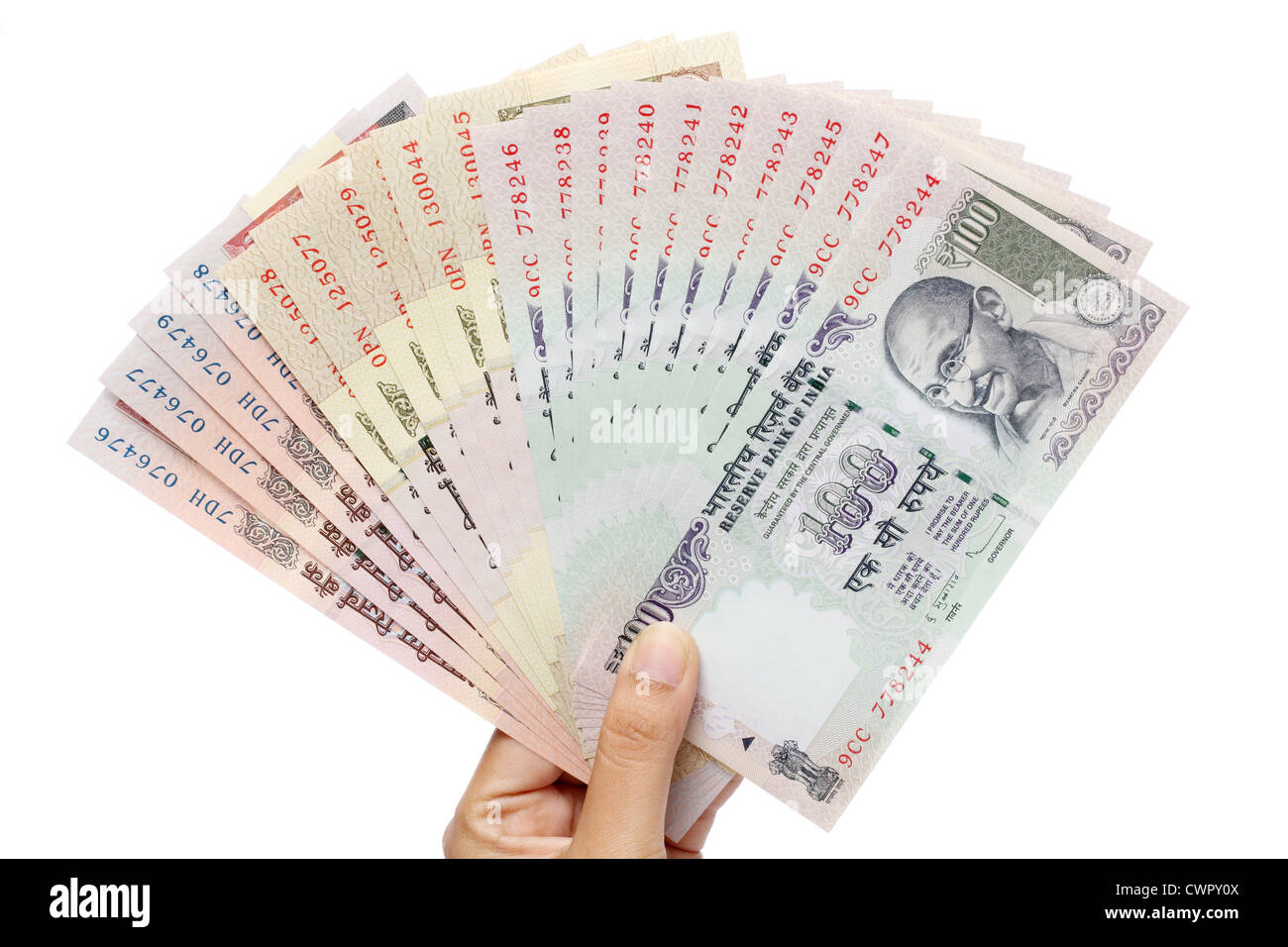 Hand holding Indian rupee notes against white Stock Photo