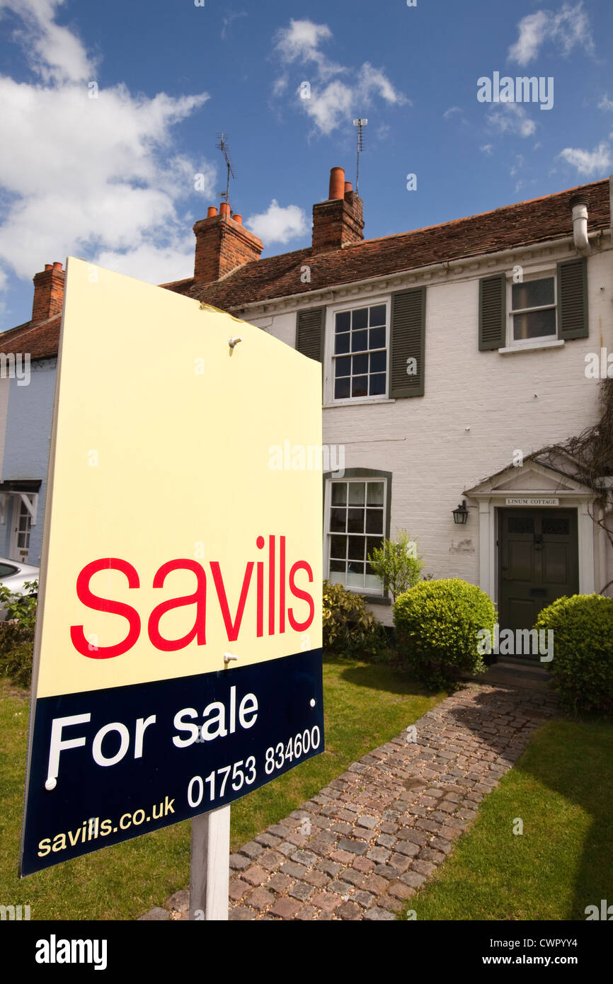 England, Berkshire, Bray Village, Ferry Road, Savills estate agents sign outside cottage for sale Stock Photo