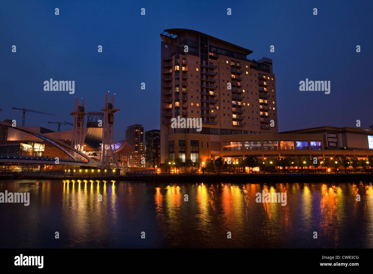 UK, England, Salford Quays, Lowry Centre and Sovereign Point over Manchester Ship Canal at night Stock Photo