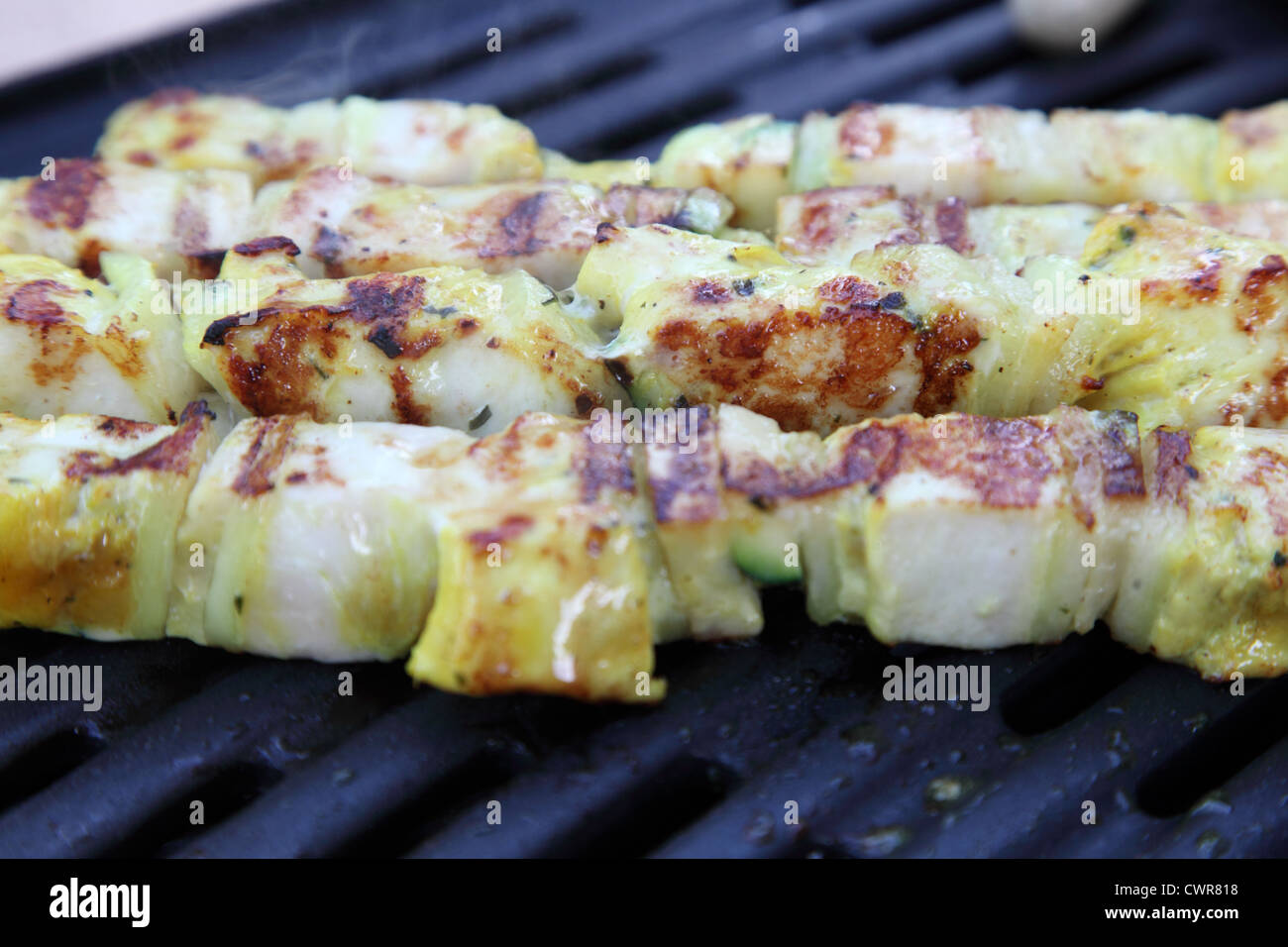 Chicken spit on bbq grill Stock Photo