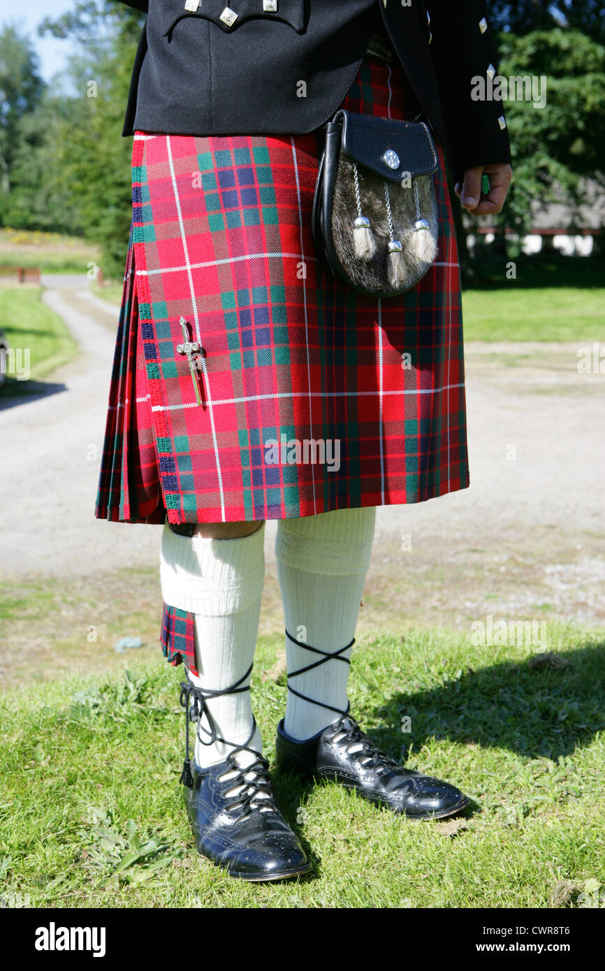 man wearing traditional scottish dress including clan fraser tartan kilt sporran hose and brogues scotland uk Stock Photo