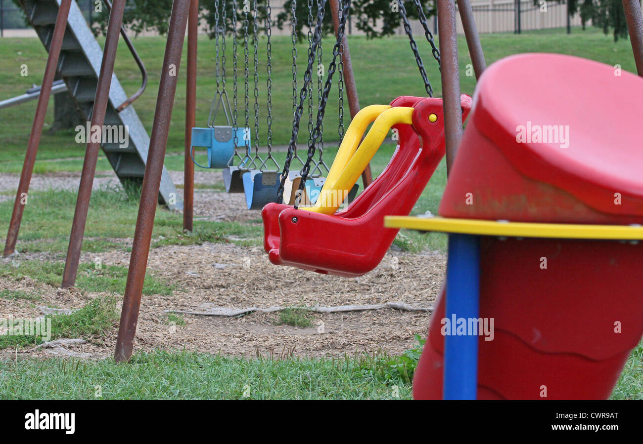 A swing set and sliding board in a public park Stock Photo Alamy