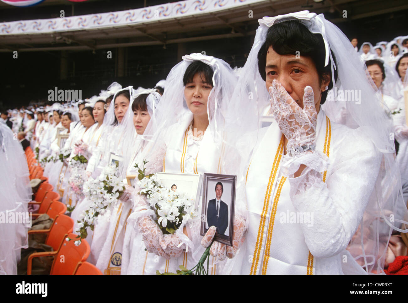 Approximately 30,000 couples get married in a Unification Church mass wedding ceremony at RFK Stadium November 29, 1997 in Washington, DC. Stock Photo