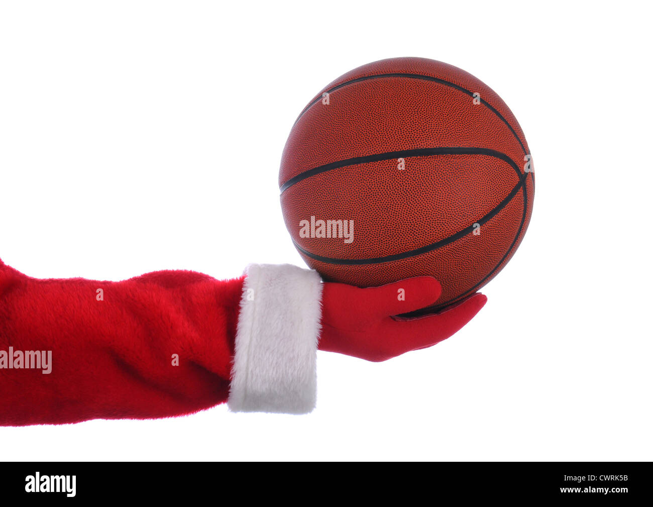Santa Claus outstretched arm holding a Basketball. Horizontal format over a white background. Stock Photo