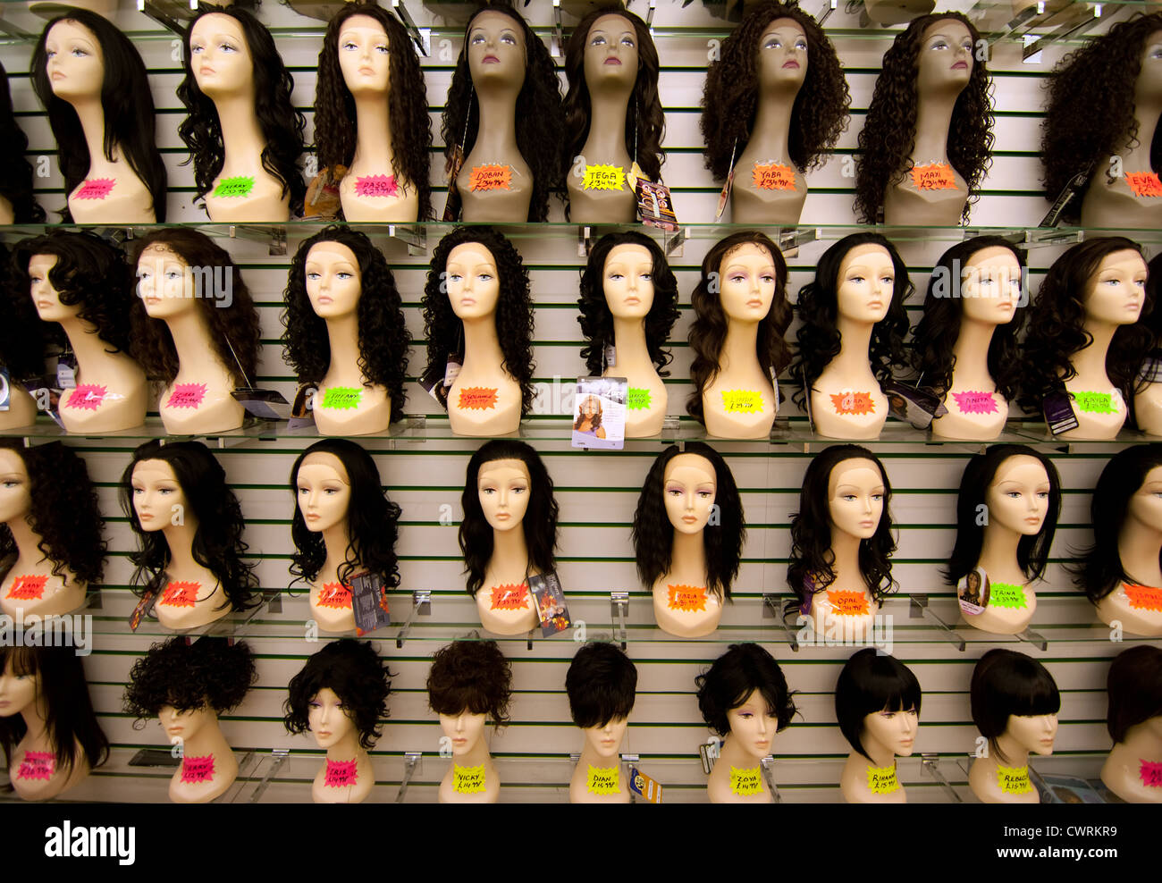a display of wigs from a shop in queens market Upton park London e13 Stock Photo