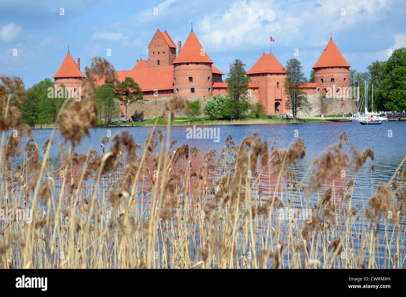 Trakai Castle surrounded by Galve lake through rushes. Most visited tourist destination in Lithuania. XIV - XV century architect Stock Photo