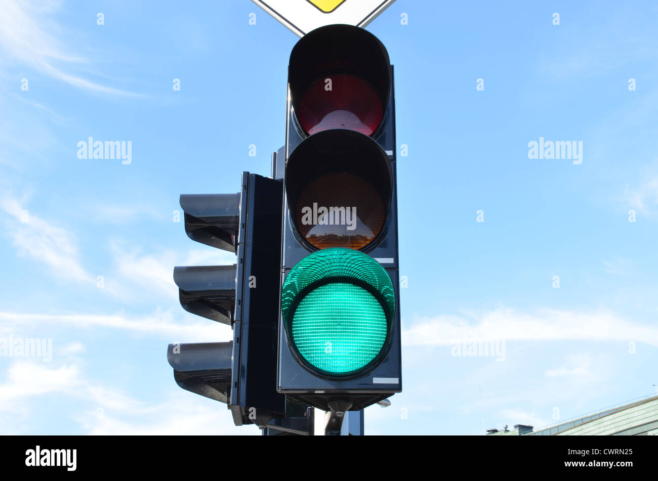 Green color on traffic light with beautiful blue sky in background Stock Photo