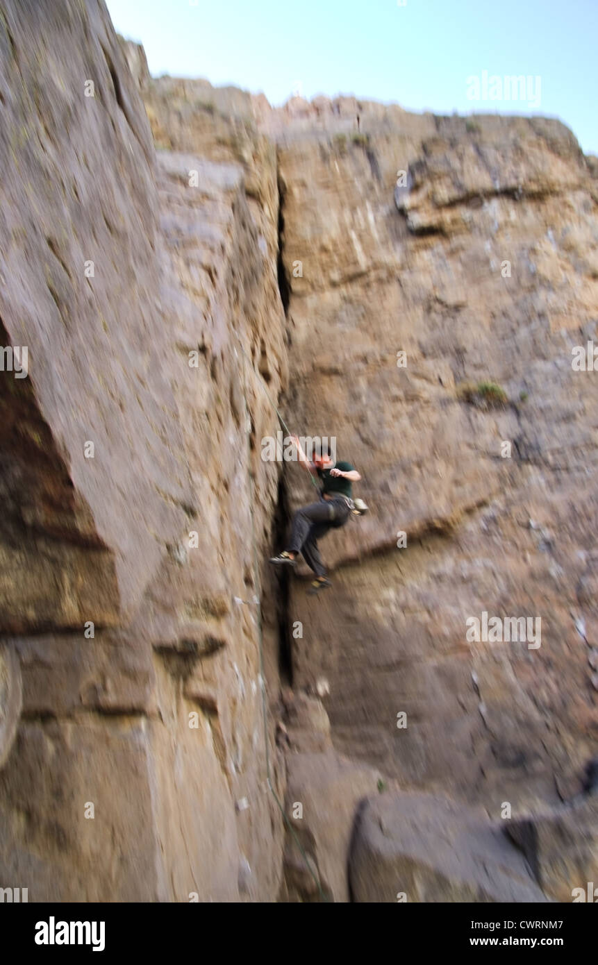 a falling rock climber with motion blur Stock Photo