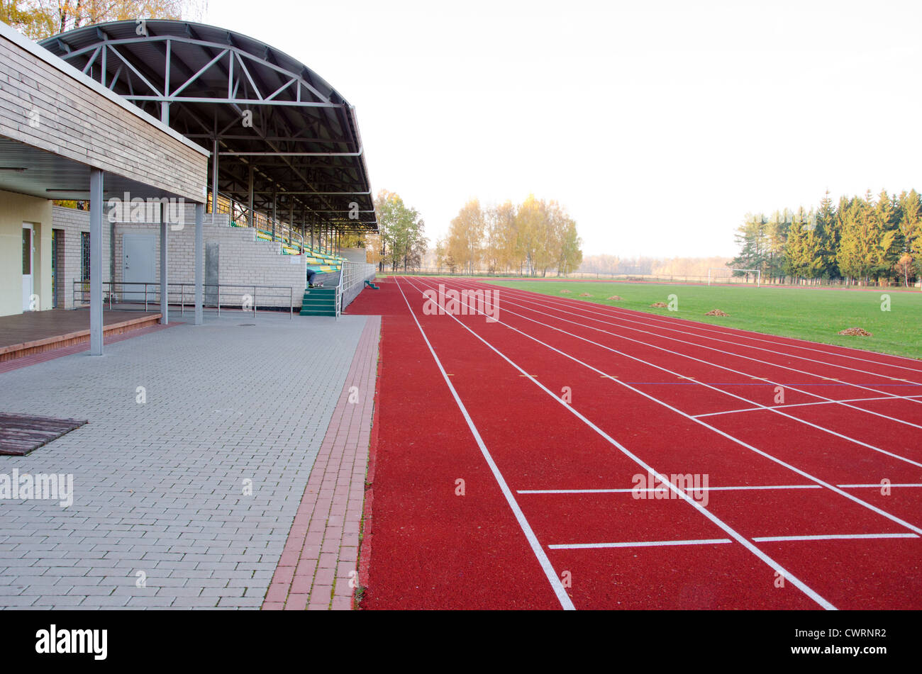 Athletics stadium with running tracks and stands and football pitch in